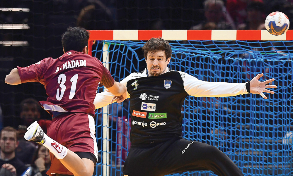 Qatar's Ahmad Madadi (left) shoots against Slovenia's goalkeeper Matevz Skok during their 25th IHF Men's World Championship 2017 quarter final handball match played at the AccorHotels Arena in Paris, France on Tuesday. Slovenia won 32-30.