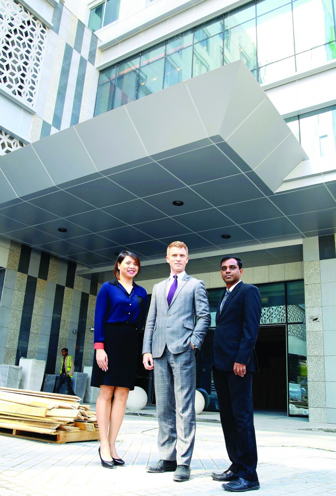 Holiday Inn officials pose for a photo in front of the hotel. Pic: Qassim Rahmatullah / The Peninsula