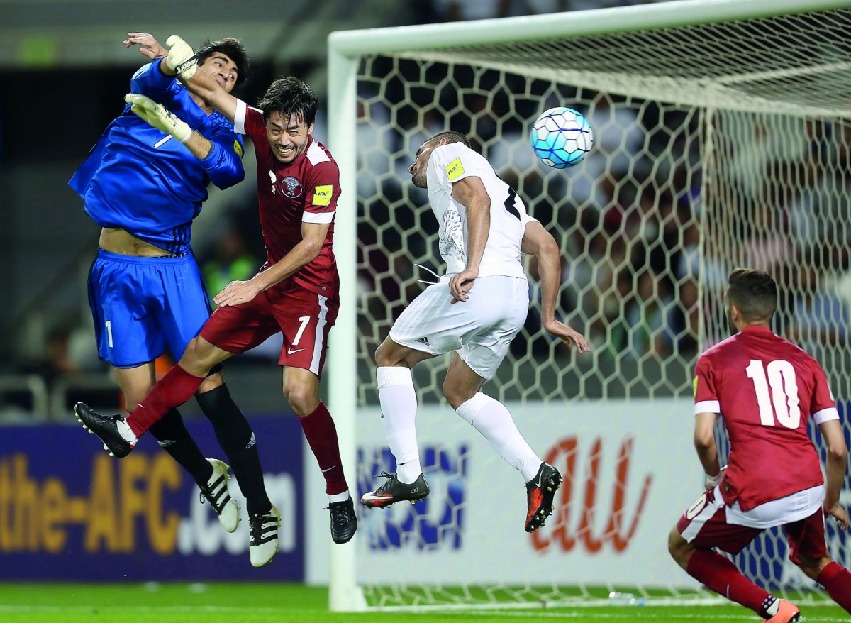 Iran's goalkeeper Alireza Safar Beiranvand (left) and Milad Mohammadi (second right) defend as Qatar's Rodrigo Tabata (second left) tries to score during the World Cup 2018 Asian qualifier played at the Jassim Bin Hamad Stadium in Doha yesterday. Iran bea