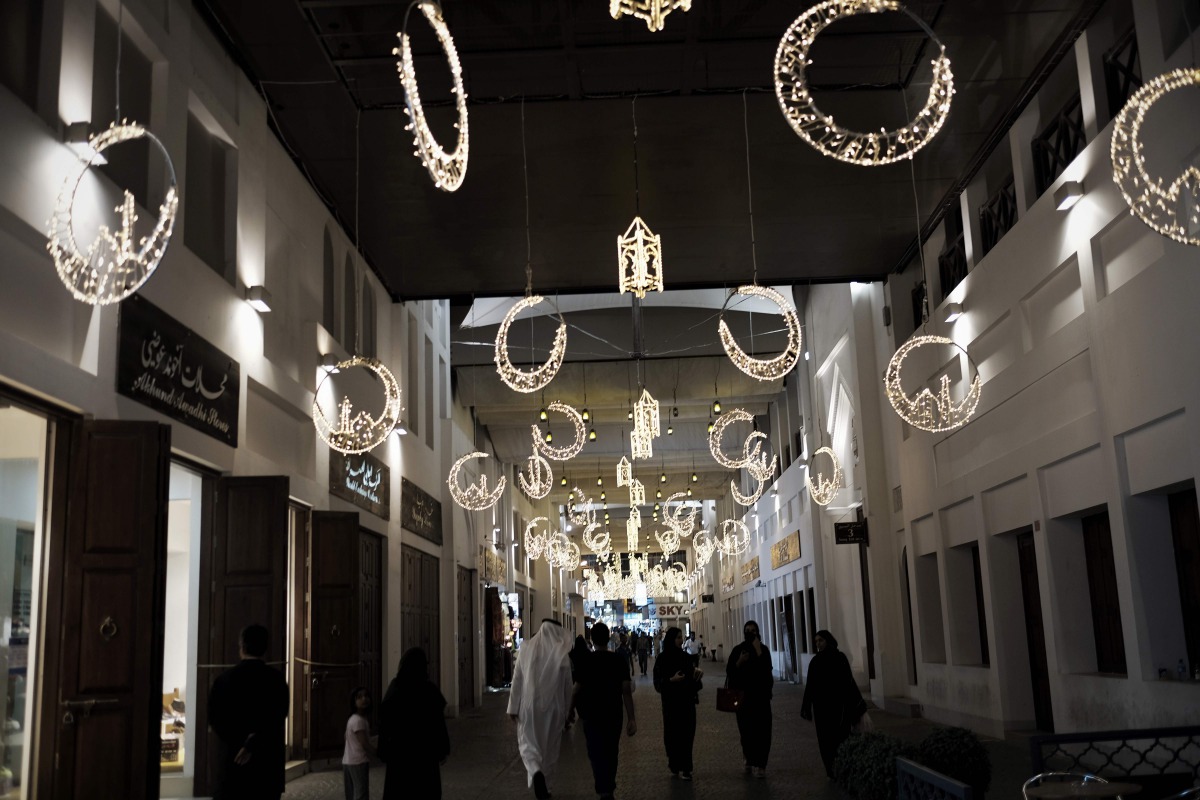 Bahrainis walk near the shops at the old Manama market late on June 10, 2016 during Ramadan (AFP / Mohammed Al-Shaikh) 