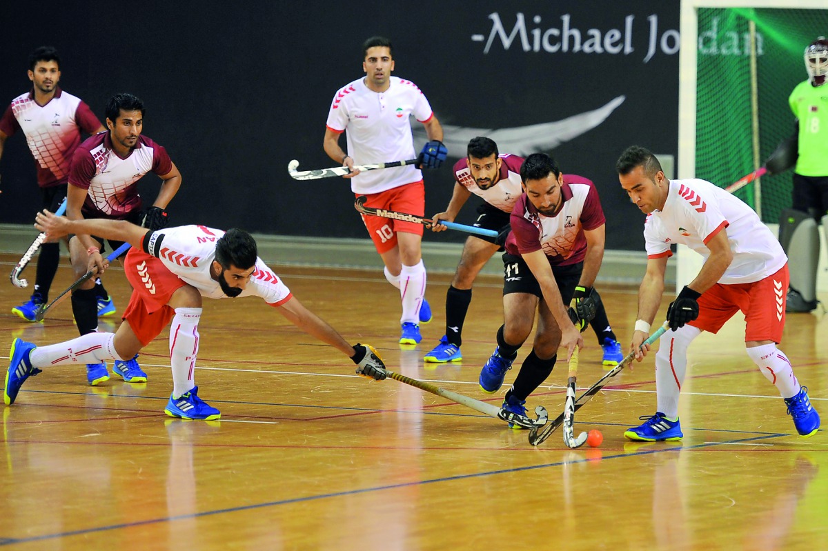 Qatar and Iran players in action during their Asia Cup Indoor Hockey Championship match played at Aspire Dome yesterday. Iran displayed a ruthless show in the second half to overshadow a gutsy performance from Qatar in the opening session, for a 9-3 victo