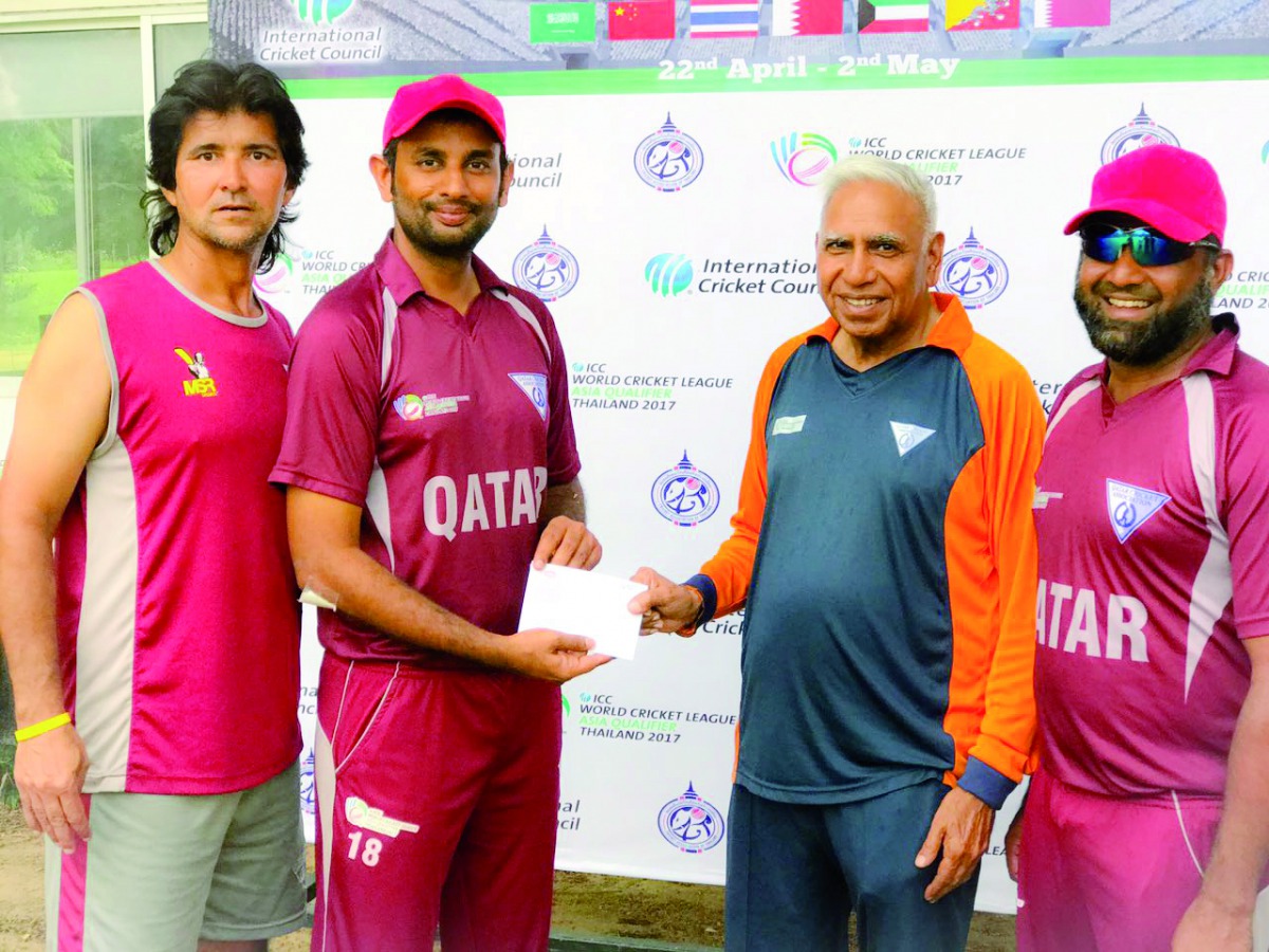 Qatar Cricket Association Operations Manager and team manager on tour, Manzoor Ahmad (third left) presenting a cash award to Mohammed Nadeem after their ICC World Cricket League Asia Region Division One tournament match against China at Gymkhana Club in C