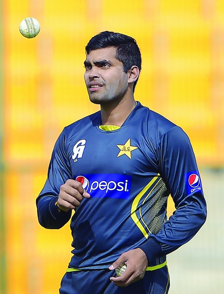 Pakistani cricketer Umar Akmal tosses a ball during a practice session at the Zayed International Cricket Stadium in Abu Dhabi, in this file photo.