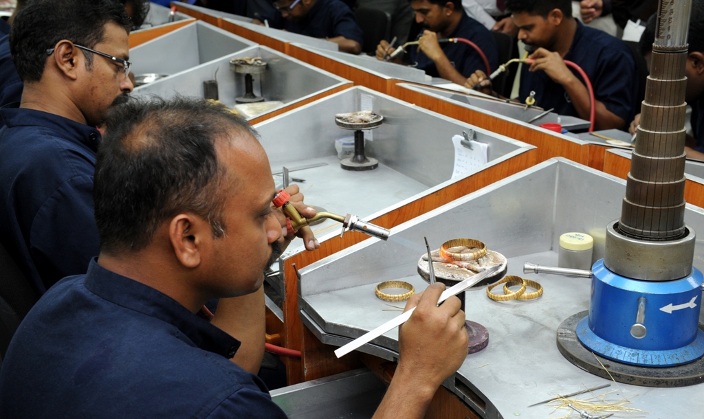 File photo of a employee working on a gold bangle.  