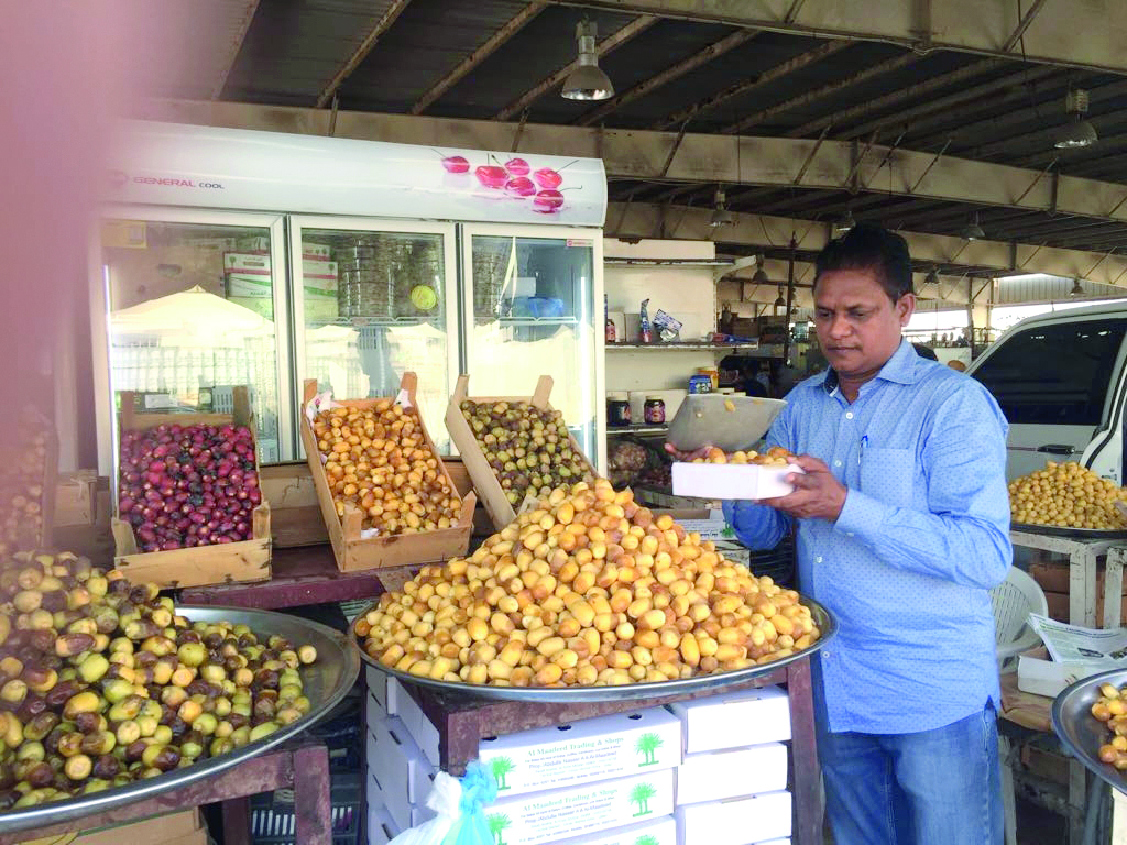 A shop keeper selling half-ripe dates at an outlet at Omani Market in Abu Hamour Central Market, yesterday. 