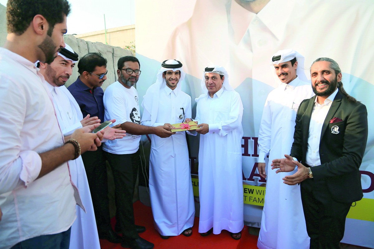 Qatari artist Ahmed Al Maadheed of the Tamim Al Majd unity icon along with other officials at the launch of the magazine.