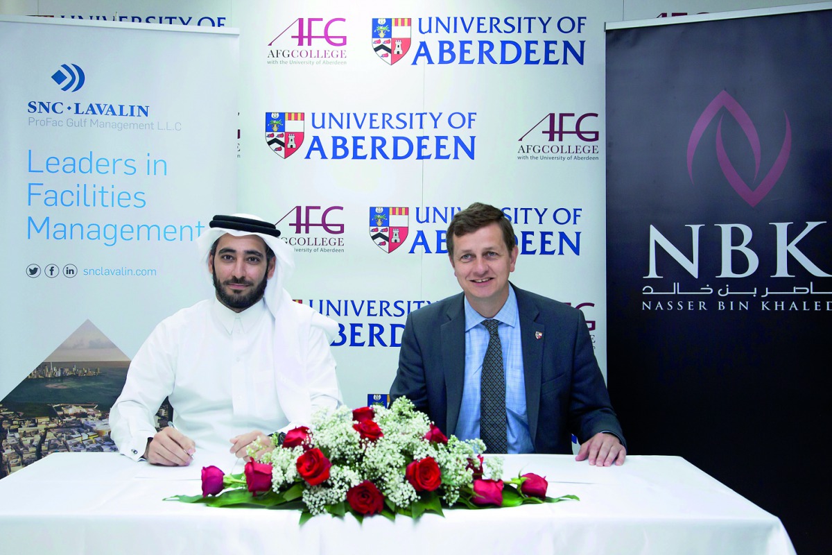 Sheikh Khalid Nawaf Al Thani (left), representing NBK & SNC–Lavalin, and Professor Richard Wells, Dean of transnational education representing AFG College, during the signing ceremony.  