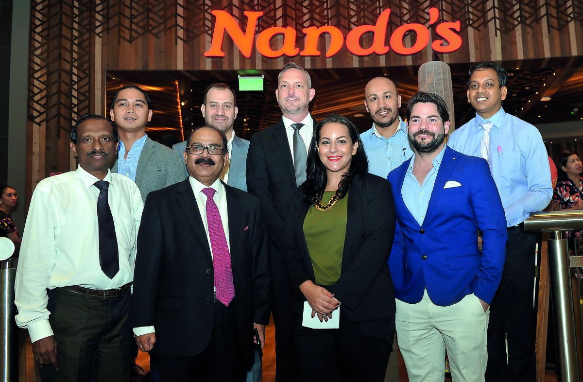 C V Rappai (second left in front row), CEO of Oryx Group for Food Services and Nando’s Qatar; Acting COO, Grant Ring (centre in back row); Branch Manager, Hani Ibrahim (second right in back row); Operation Manager, Steven Holloway (right in first row); Ma