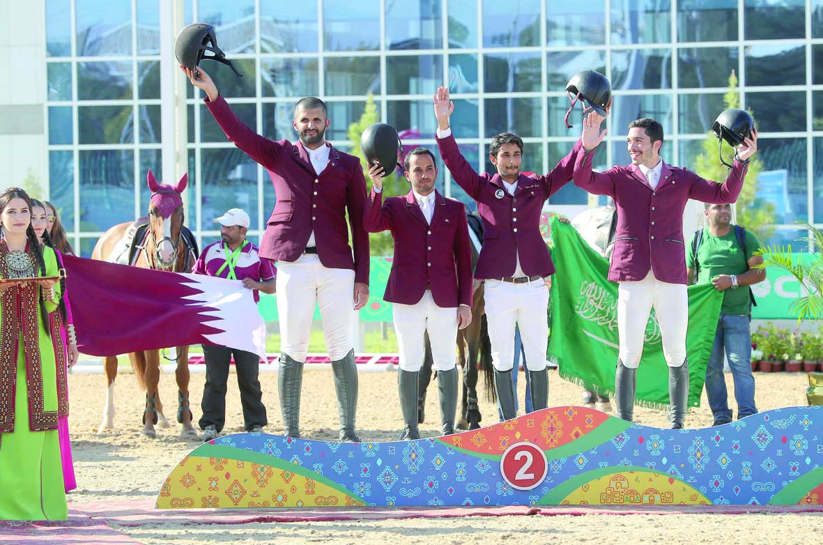 The Qatari team, comprises of Al Attiyah, Faleh Al Ajami, Salmen Sultan Al Suwaidi and Salman Mohammed Al Emadi pose for a photograph after winning the silver medal in the team  event of the equestrian competition.