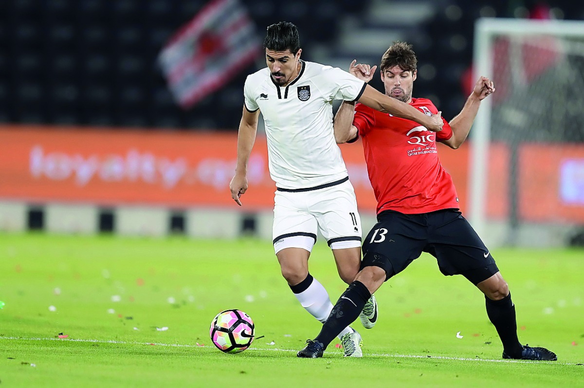 Al Sadd’s Baghdad Bounedjah (left) and Al Rayyan’s Gonzalo Viera in action during a QSL match in this file photo. 