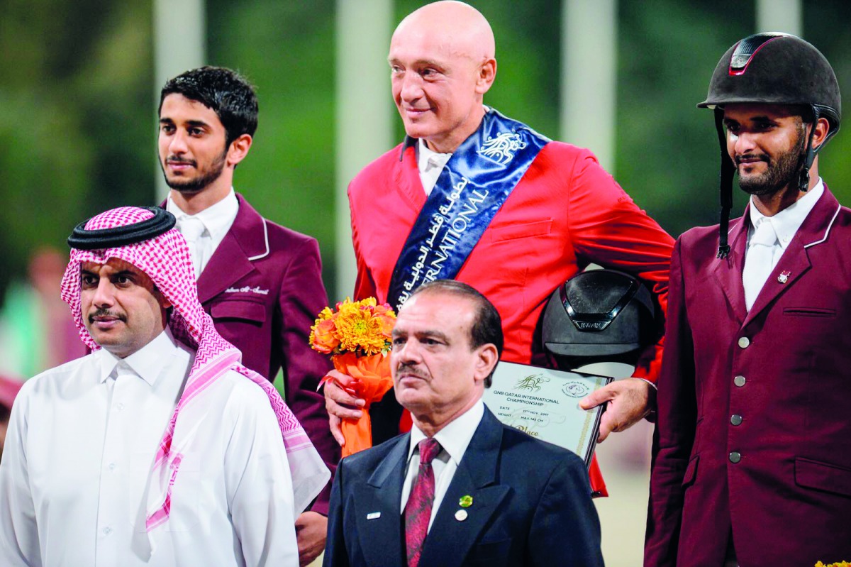 Podium winners of the feature event of the day, Russian rider Vladimir Tuganov (top centre), Qatari riders Salmeen Sultan Al Suwaidi (top left) and Hamad Al Attiyah pose for a photograph with Col (Retd) Usman Nasir, Executive Board Member of Equestrian Fe