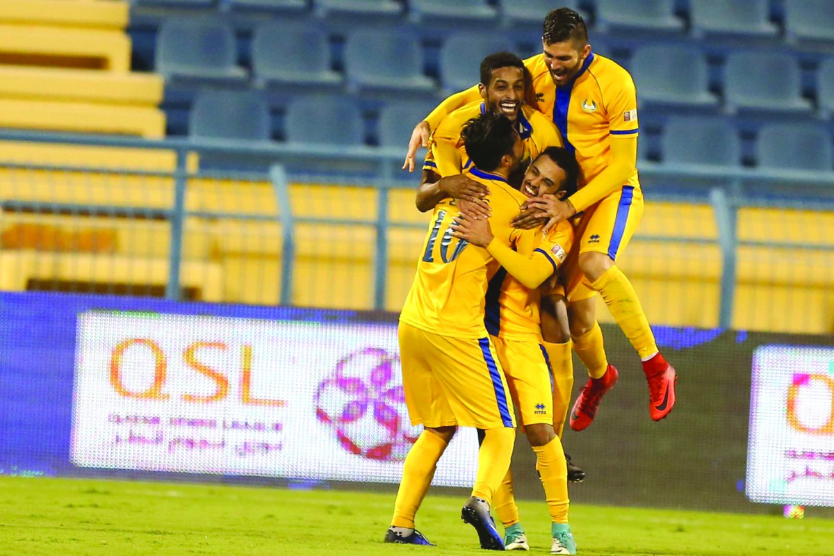 Al Gharafa players celebrate after scoring against Al Arabi yesterday.