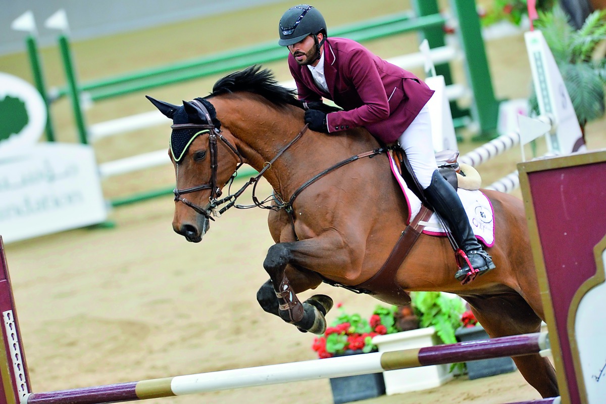 Mubarak Yousuf Al Rumaihi guides  Viking D over an obstacle during the Open Class of Hathab  Tour yesterday.