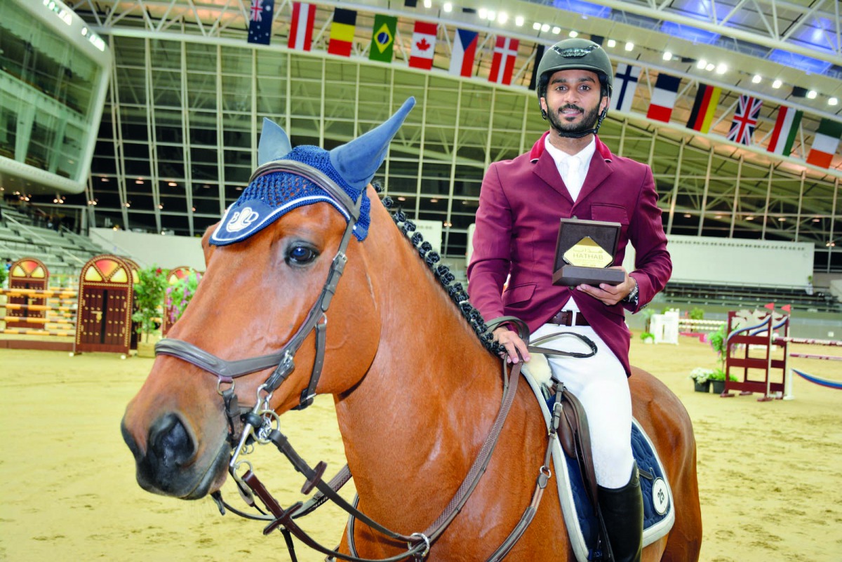 Abdullah Ali Al Ajeil, winner of the Big Tour of the seventh leg of Hathab Equestrian Tour, poses for a photograph after receiving his trophy at Al Shaqab Arena yesterday.