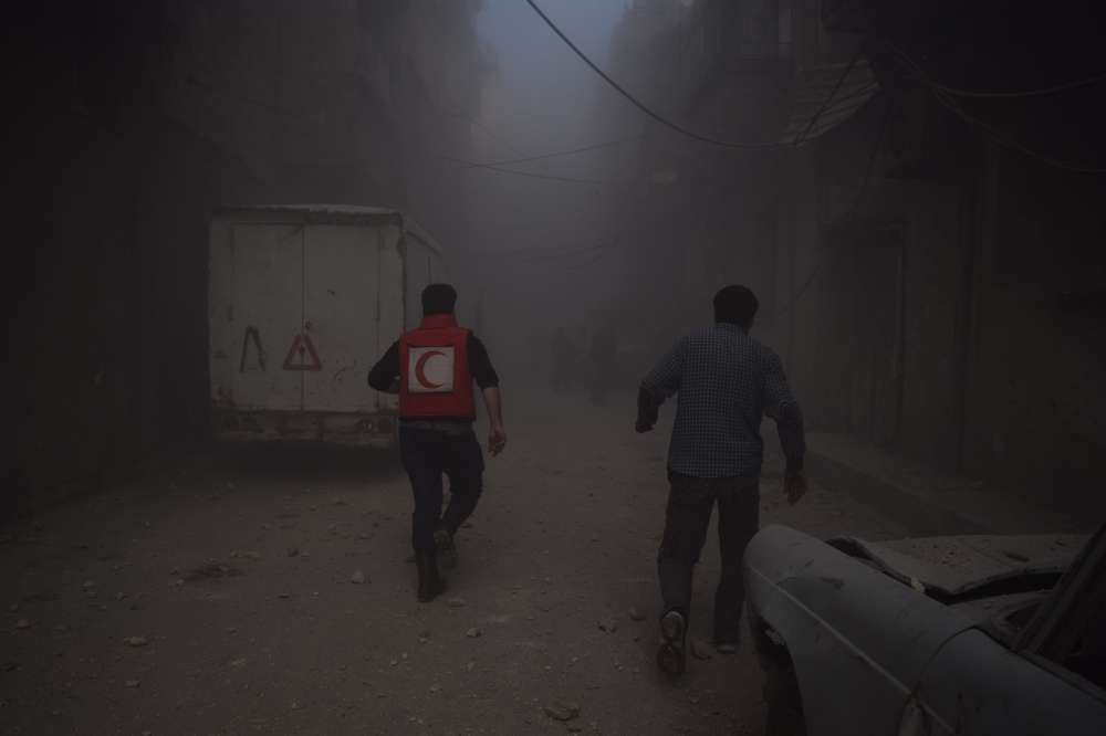 Citizens and rescue team members inspect the destroyed buildings after Assad regime forces carried out an airstrike over the de-escalation zone in Douma town of Eastern Ghouta in Damascus, Syria on February 24, 2018. Mouneb Abu Taim - Anadolu