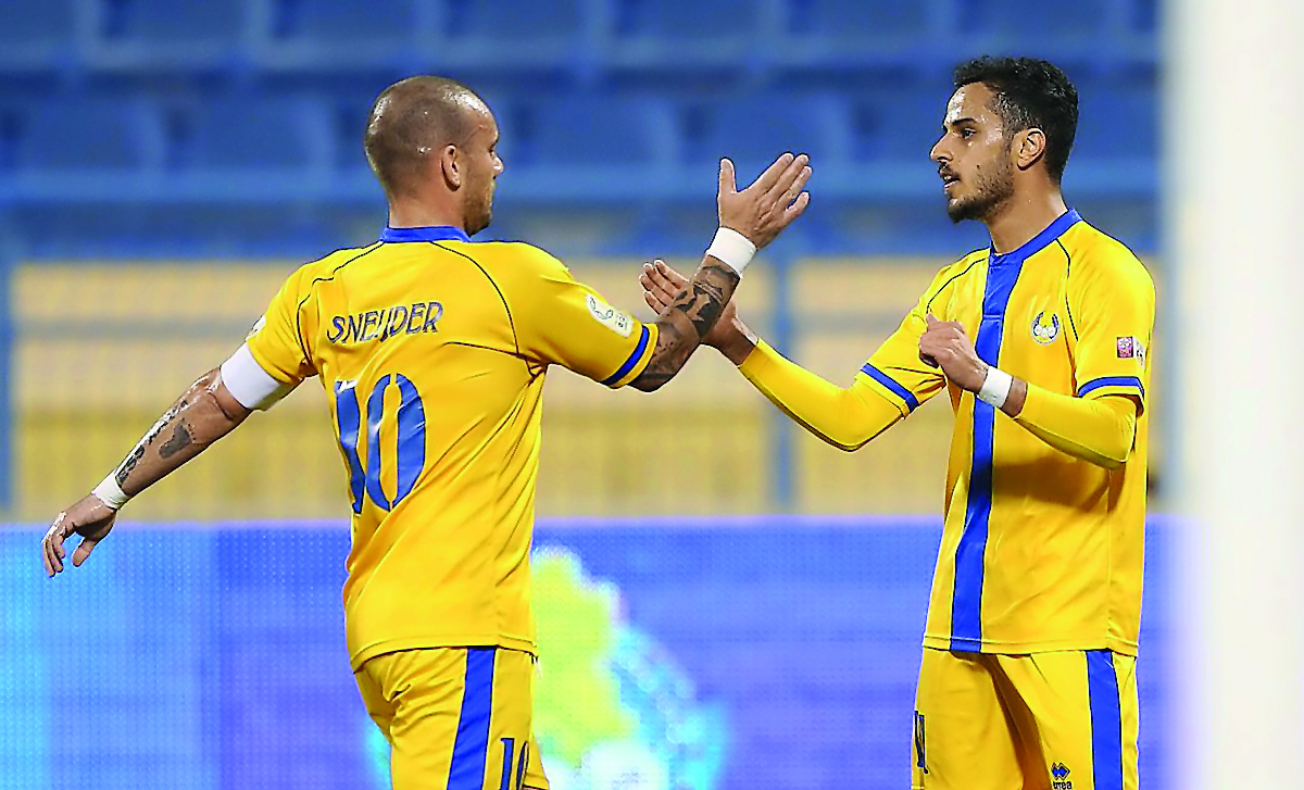 Al Gharafa’s Wesley Sneijder (left) is congratulated by a team-mate during a QNB Stars League (QSL) match in this file photo.