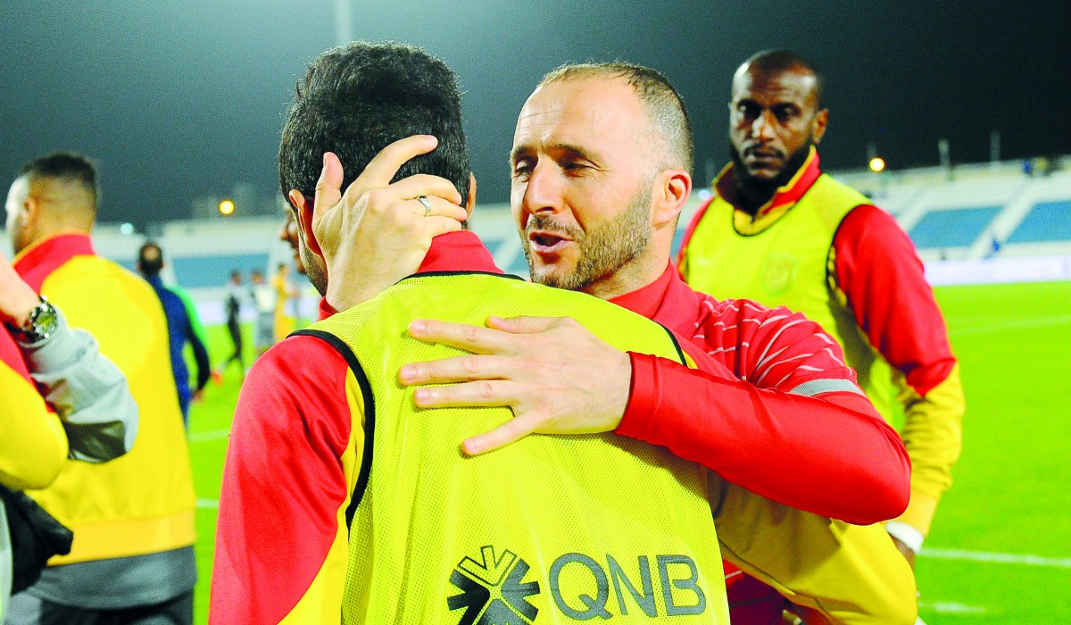 Al Duhail coach Djamel Belmadi celebrates with a player after his team sealed QSL title with a 5-0 victory over Al Kharaitiyat during Round 20. 