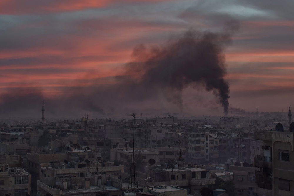 Smoke rises after Assad Regime carried out an airstrike at Douma town of Eastern Ghouta in Damascus, Syria on April 07, 2018. ( Mouneb Taim - Anadolu Agency )