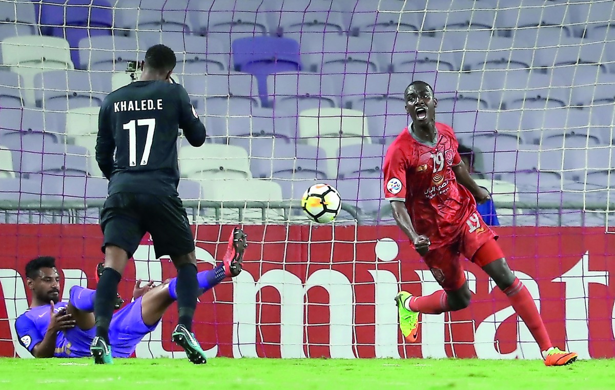 Al Ain’s Khalid Eisa (left) reacts as Al Duhail’s Almoez Ali celebrates his goal during the AFC Champions League match played at the Hazza Bin Zayed Stadium in Al Ain, United Arab Emirates yesterday. 