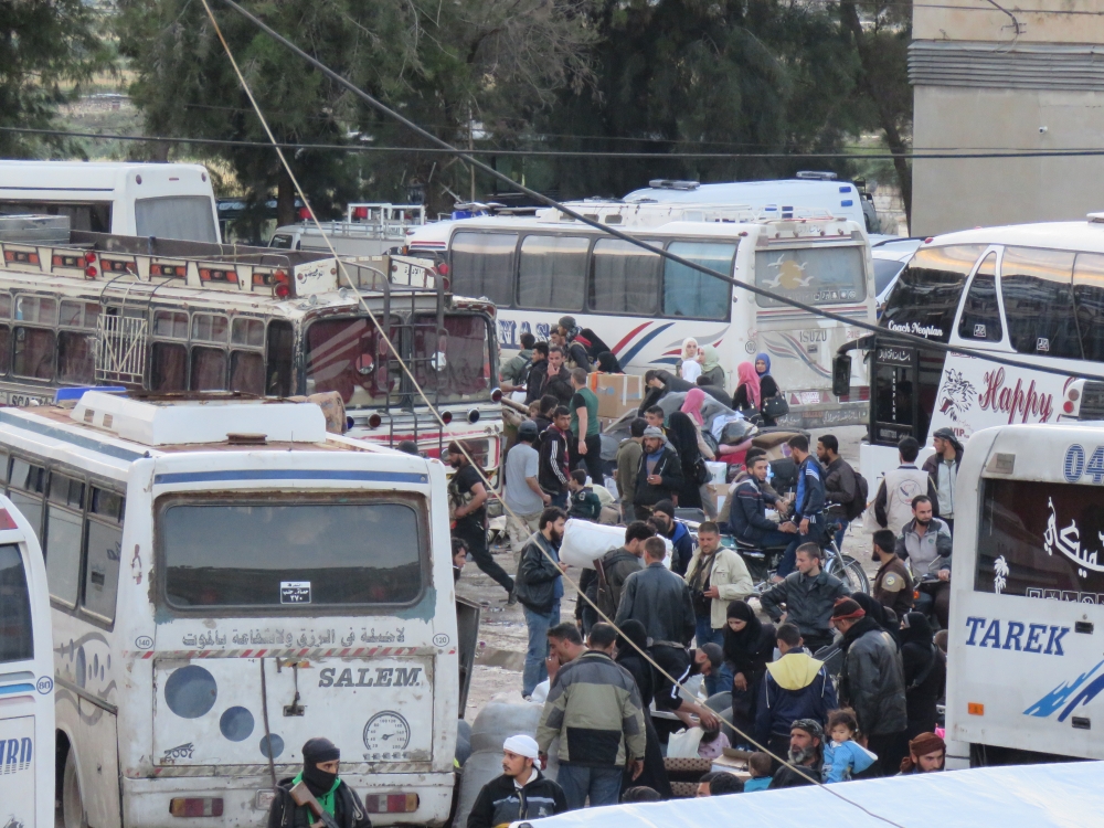 The sixth convoy carrying civilians depart from Homs, Syria due to Assad regime's intense assaults and blockage as part of the compulsory evacuation to reach Idlib and western Aleppo on May 13, 2018. Hazem Gab - Anadolu
