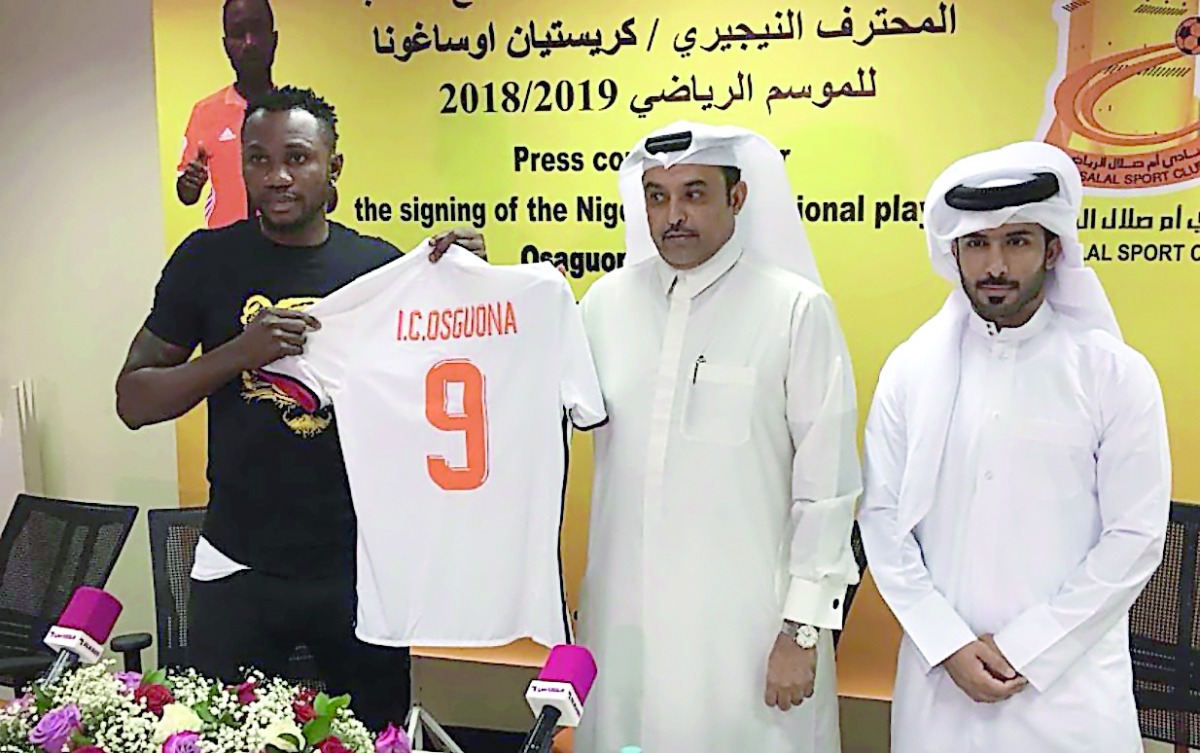 Christian Osaguona displaying his Umm Salal jersey along with top Umm Salal officials.  