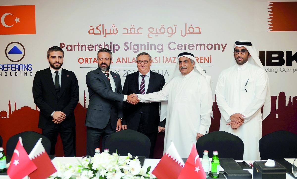 Sheikh Ali bin Hamad Al Thani (second right), President of HBK Contracting Company, greets Servet Serdar Ucar (second left), Chairman of Referans holding, in the presence of Fikret Ozer (centre), Ambassador of Turkey; Serkan Ucar (left), CEO of Referans H