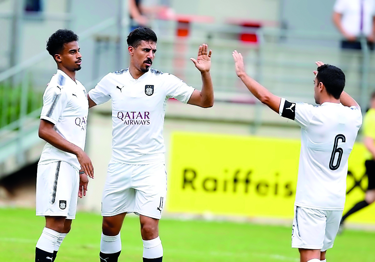 Al Sadd’s Baghdad Bounedjah (centre) is congratulated by team-mates Akram Afif (left) and skipper Xavi Hernandez during their third and final friendly match of the pre-season camp in Austria against Slovenian side NK Krka yesterday.  