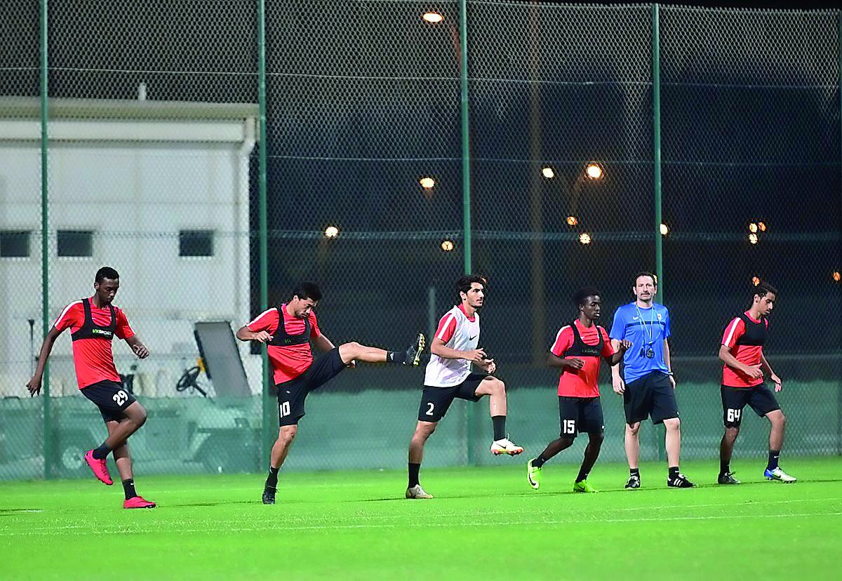 Al Rayyan’s Rodrigo Tabata (second left)  train along with team-mates as new coach Rodolfo Arruabarrena (second right) looks on during a training session in Doha, yesterday. 