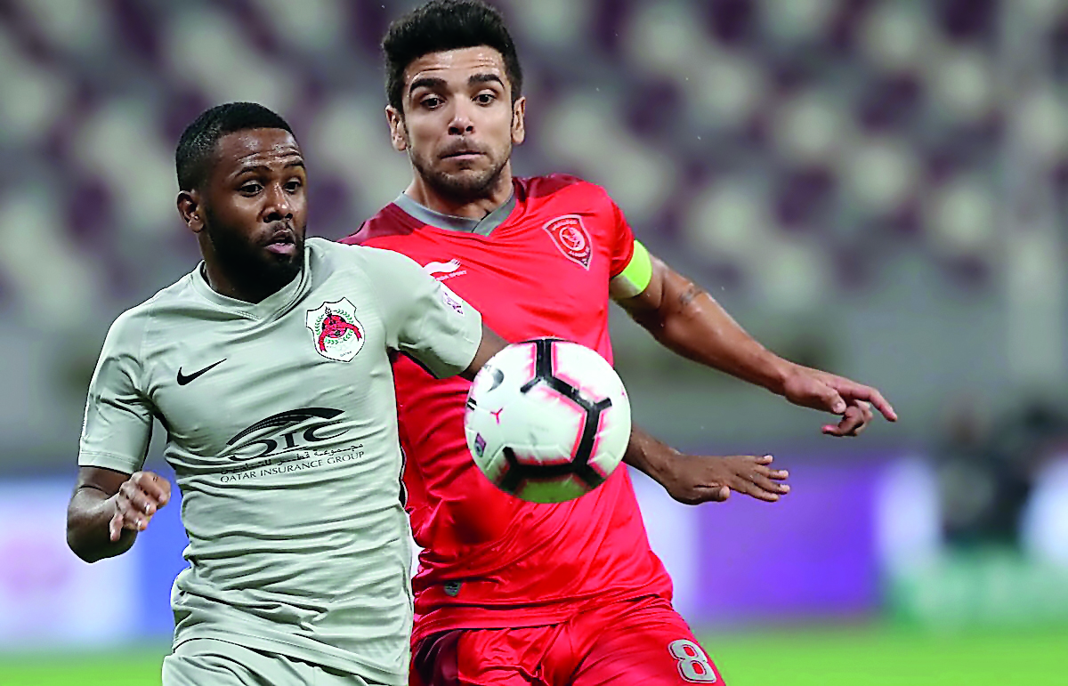 Al Rayyan’s Khalfan Ibrahim (foreground) and Al Duhail captain Luiz Martin Junior vie for the ball possession during their QSL match, yesterday.  