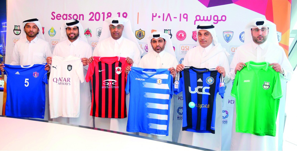 A group photo of officials from Group B teams along with teams’ jerseys.   