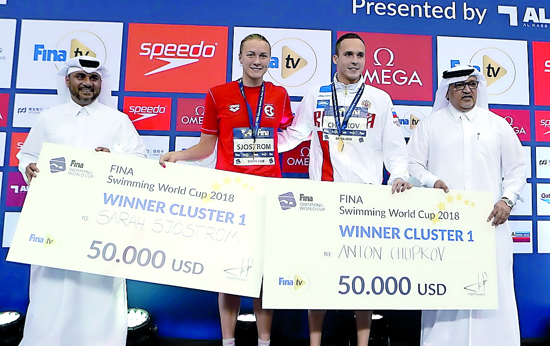 The FINA Swimming World Cup 2018 Doha edition cluster 1 winners, Swedish sprint queen Sarah Sjostrom and Russia’s Anton Chupkov (third left) pose for a photograph with the President of Qatar Gymnastics Federation Ali Al Hitmi (right) during the presentati