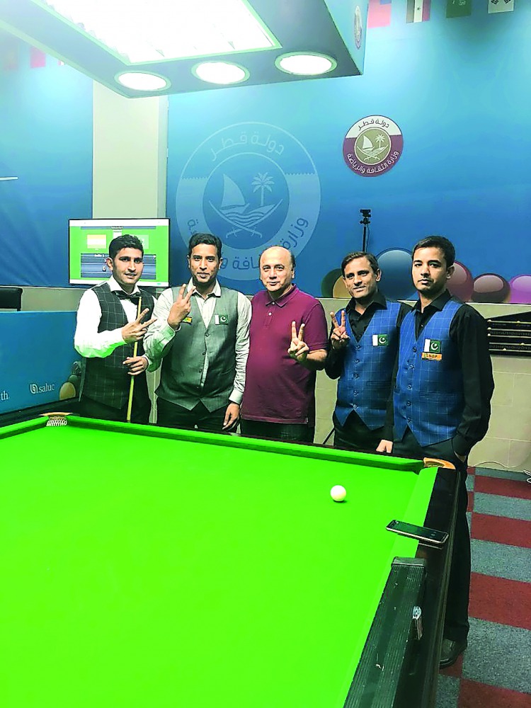 Pakistan 1’s Babar Masih (left) and Muhammad Asif (second left) along with Pakistan 2’s team members and Pakistan Billiards and Snooker Federation official Alamgir Sheikh (centre) pose for a group picture on Friday in Doha.   