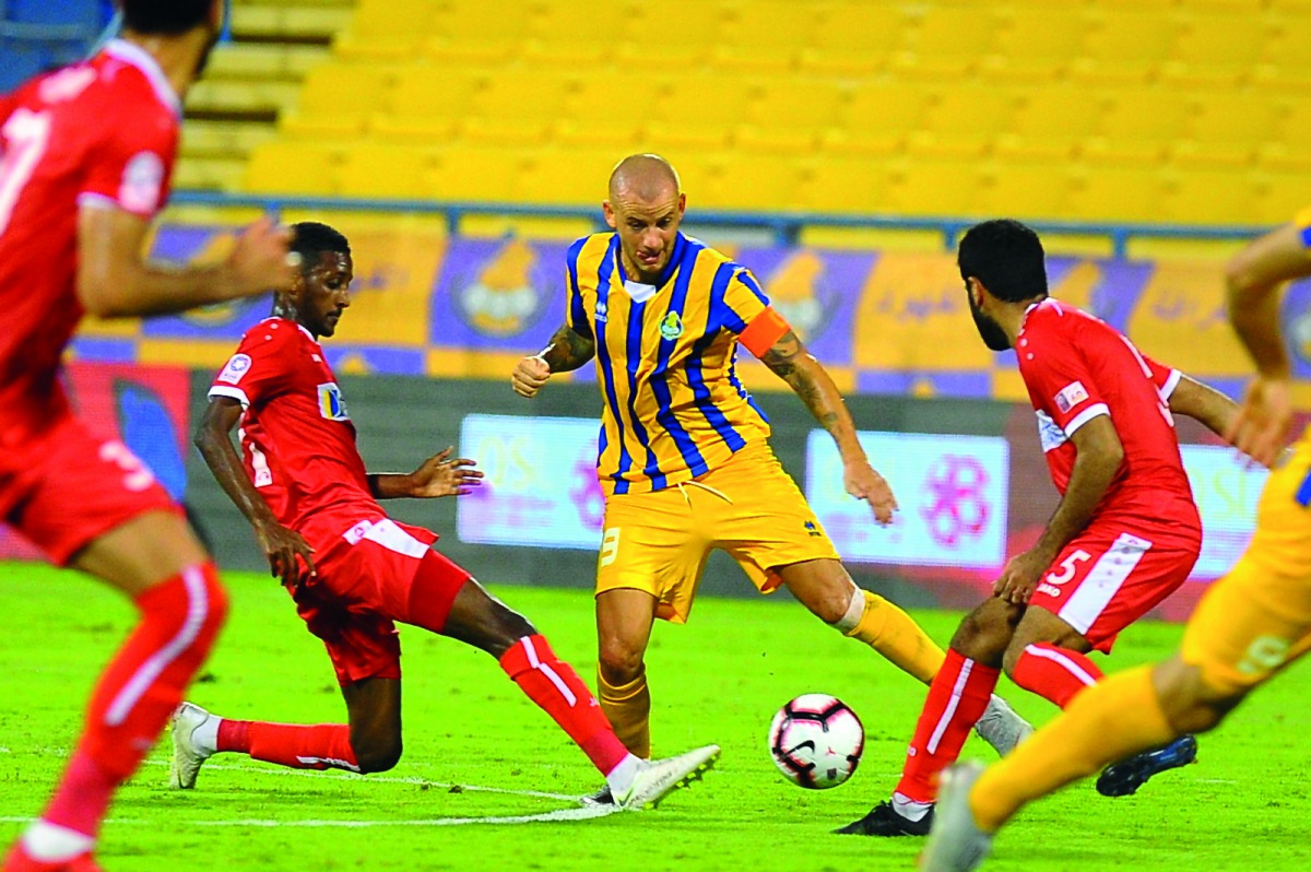 Players of Al Arabi and Al Gharafa vie for ball possession during their QNB Stars League match in Doha yesterday.