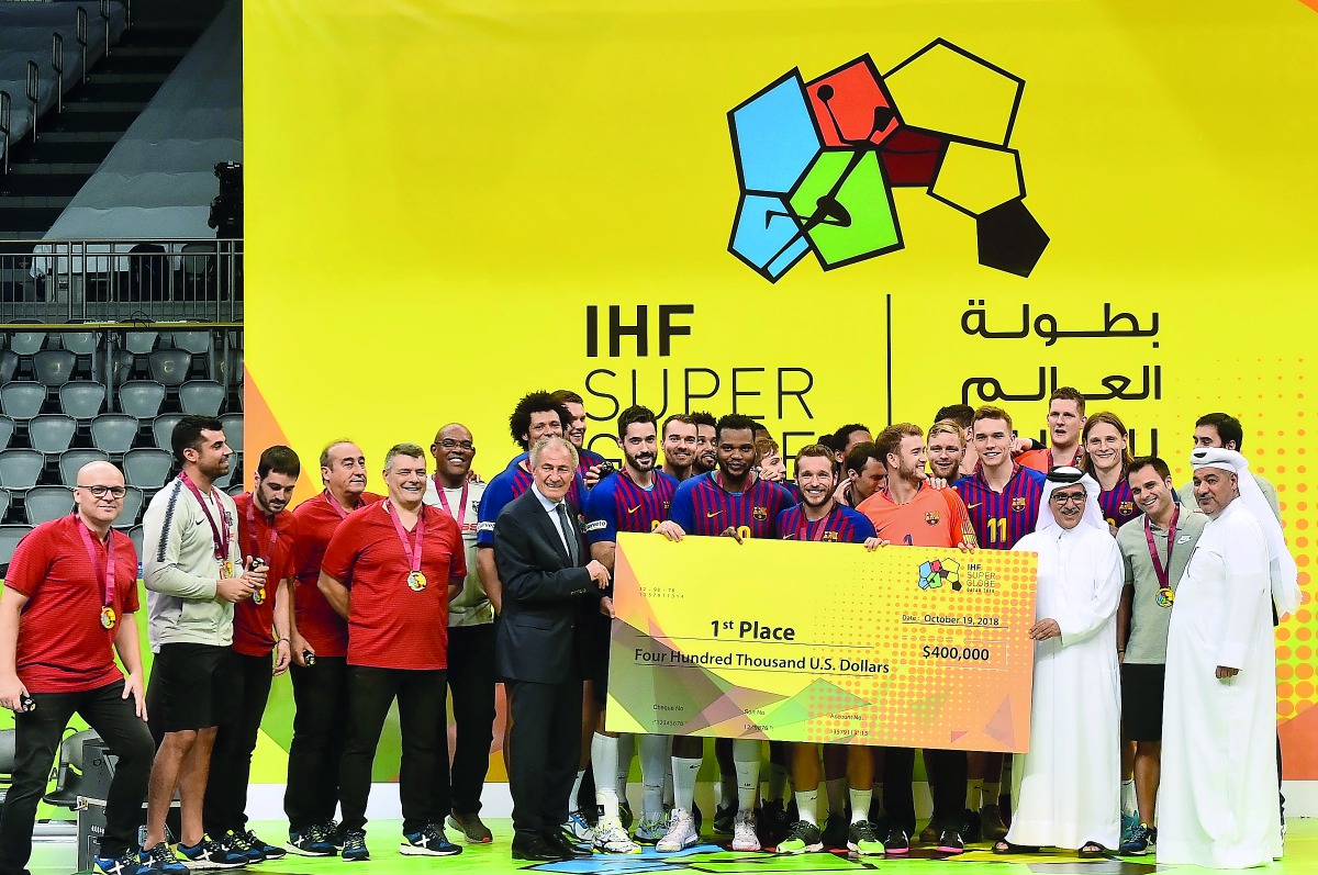 International Handball Federation (IHF) President Dr Hassan Moustafa and Qatar Handball Association (QHA) President Ahmed Mohammed Al Shaabi handing over the prize cheque to IHF Super Globe champions Barcelona  at the Al Duhail Sports Complex in Doha yest