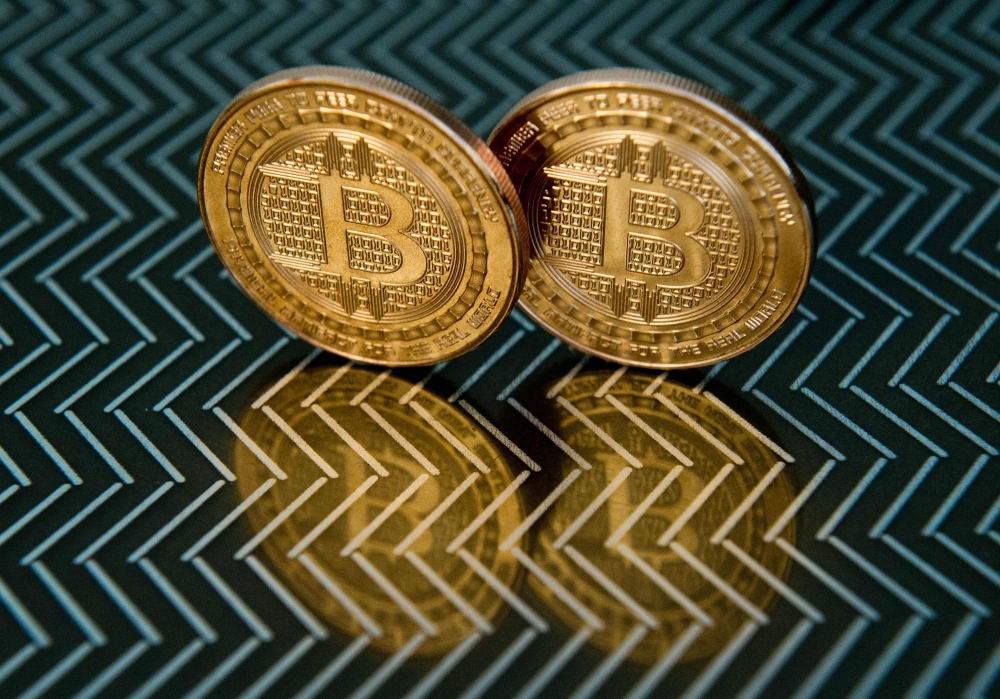 FILE PHOTO: This June 17, 2014 photo taken in Washington, DC shows bitcoin medals. Bitcoin may be the fraud of the century, depending on whom you believe, or it could be a gold mine for early adopters.  AFP / KAREN BLEIER