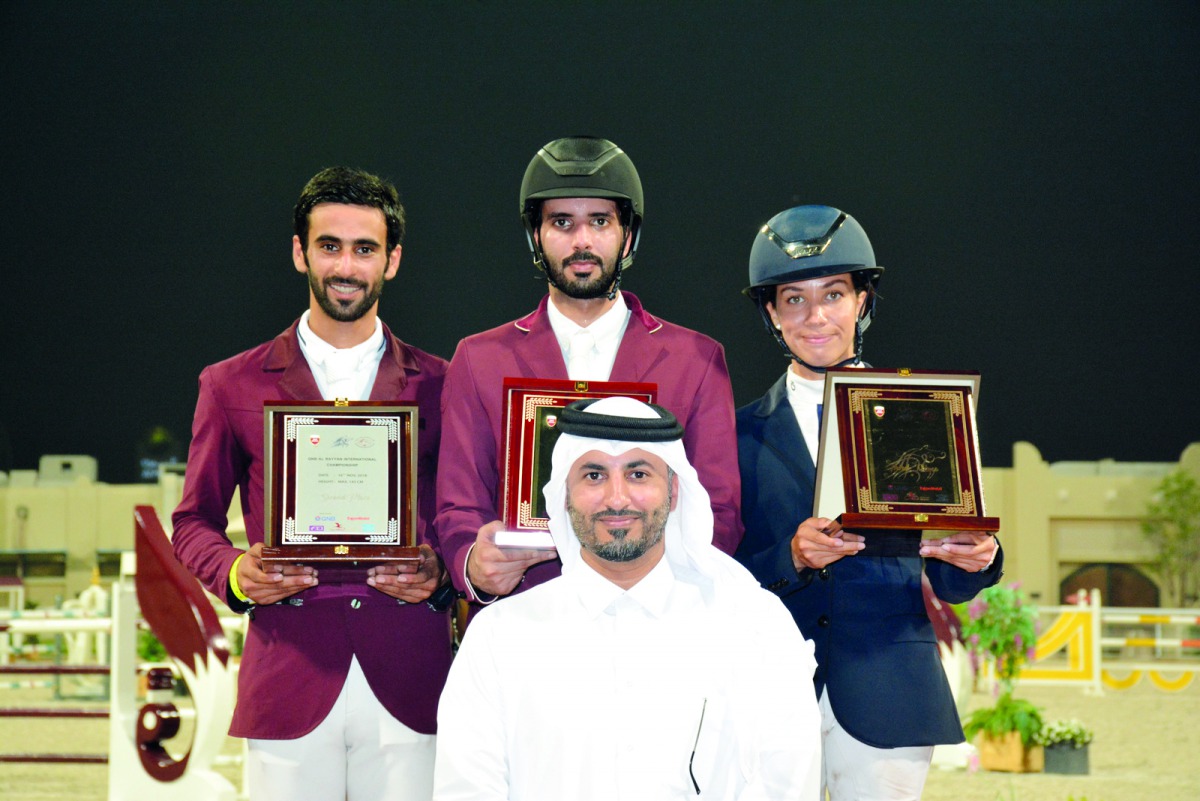 Tournament Director Ali Al Rumaihi poses for a photograph with the podium winners of the feature event on day two.