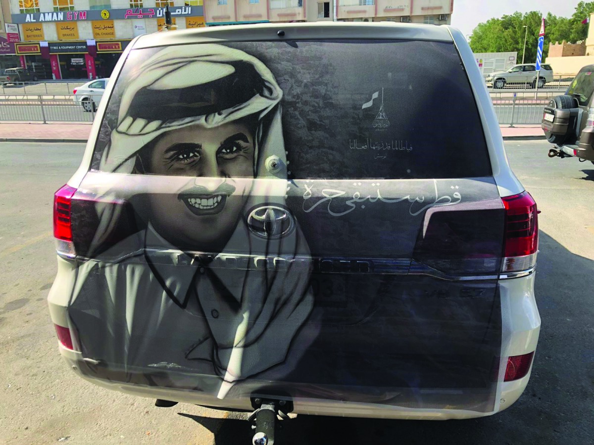 A car with the image of H H the Amir. 