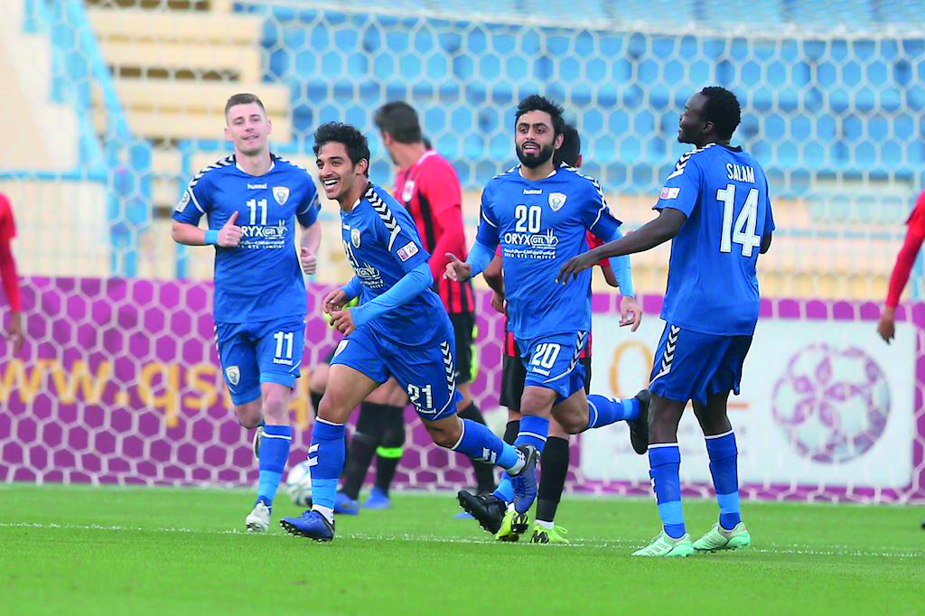 Al Kharaitiyat’s Abdul Hadi Amin celebrates with team-mates after scoring a goal against Al Rayyan during their QSL Cup quarter-final match, yesterday.