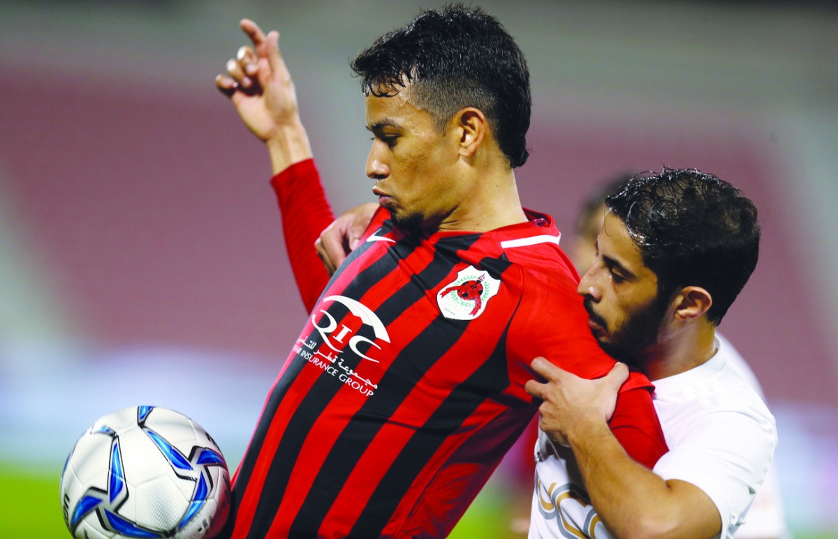 Lucca Brito of Al Rayyan (in red)