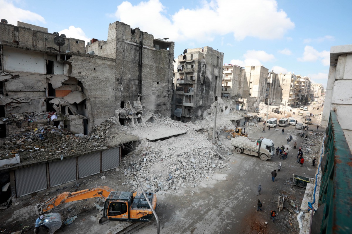 Tractors and trucks remove the rubble from buildings that were heavily damaged during battles between rebel fighters and regime forces, in the former opposition held district of Salaheddin in the northern Syrian city of Aleppo on February 11, 2019. AFP / 