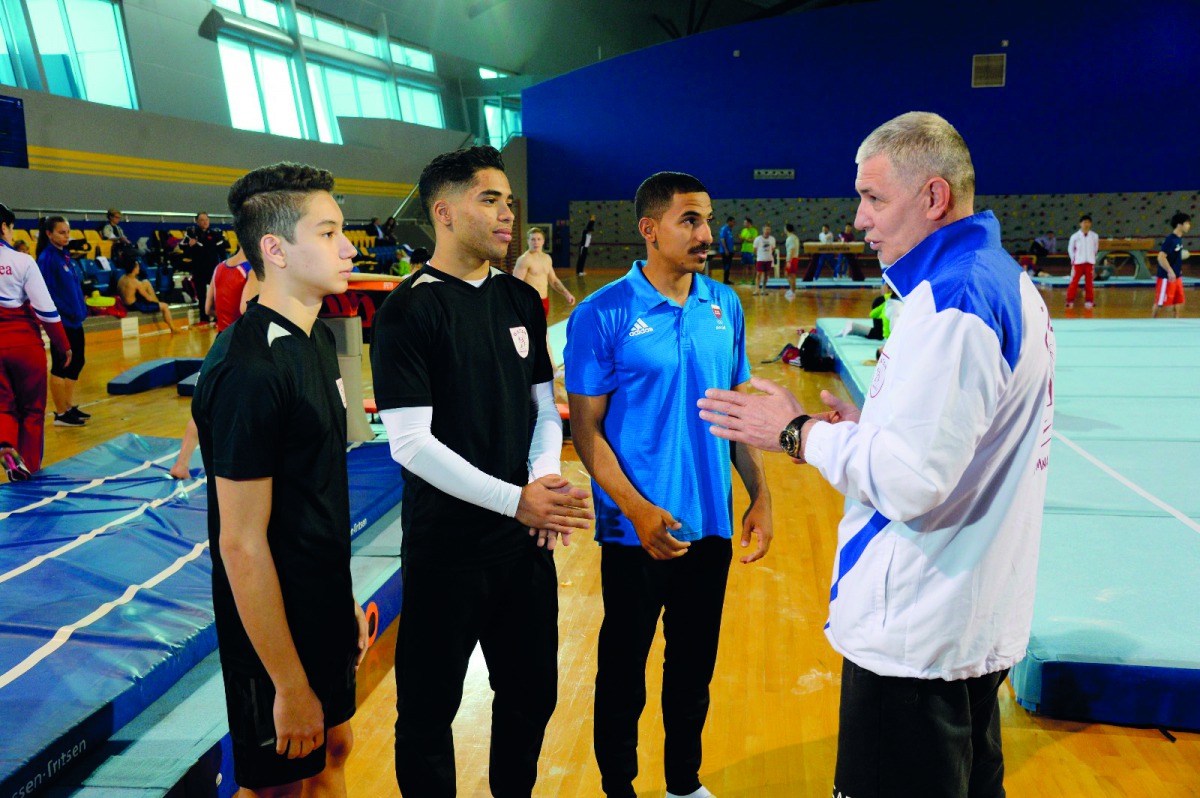 From left: Qatari gymnasts Raslan Saoud, Ahmed Mosa and Ahmed Al Dayani speak to their coach during a training session at Aspire Dome. 