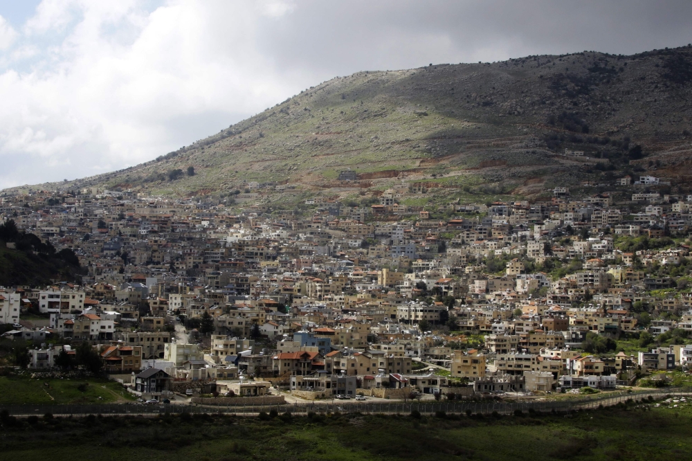 A picture taken from the Syrian town Ain al-Tineh shows the Druze town of Majdal Shams in the Israeli- annexed Golan Heights on March 26, 2019.   AFP / Louai Beshara