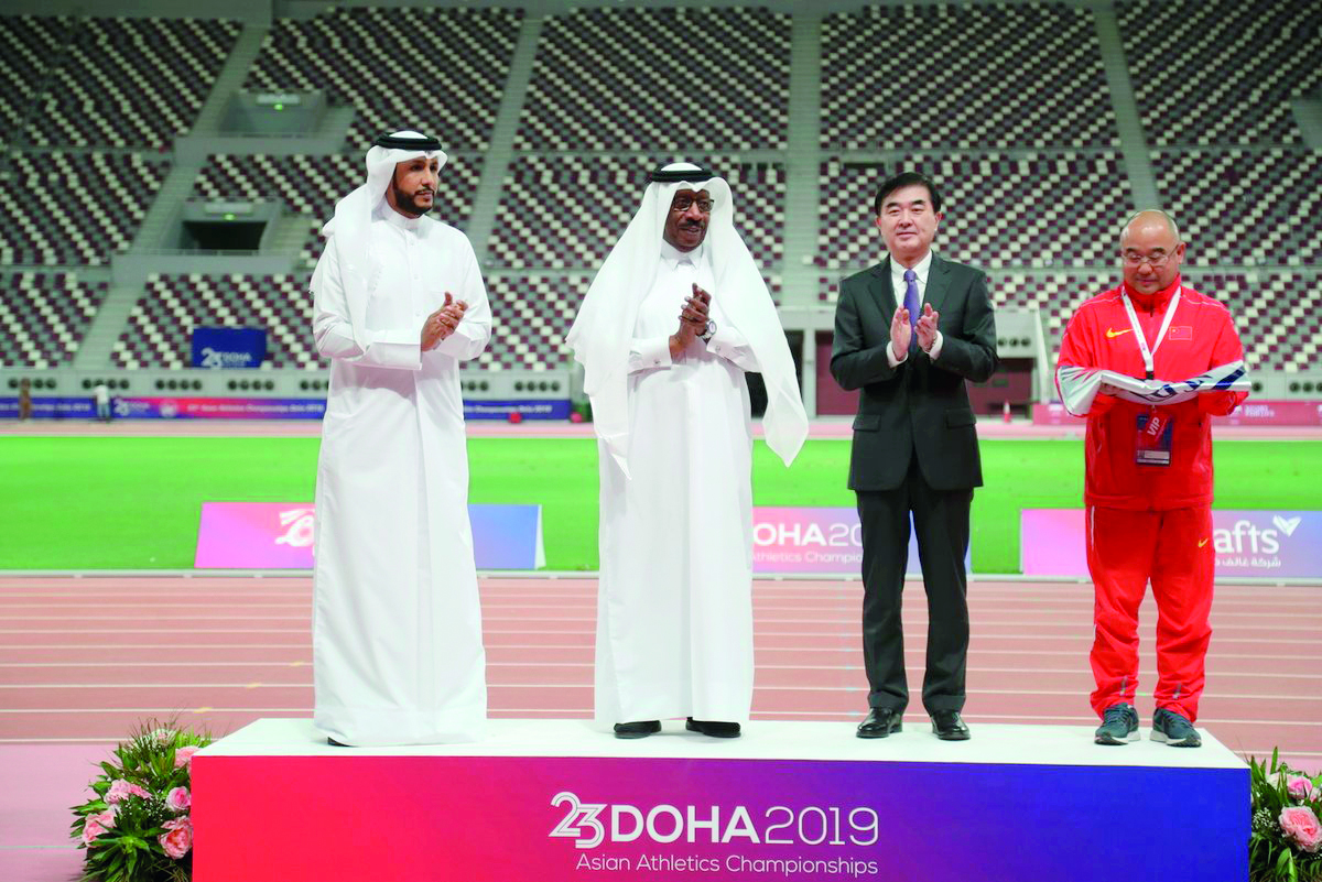 Gen. Dahlan Al Hamad (second left),  Chairman of the Local Organising Committee of the 23rd Asian Athletics Championships, poses for a photograph after handing over the championship flag to China, which will host the next edition of the continental event.