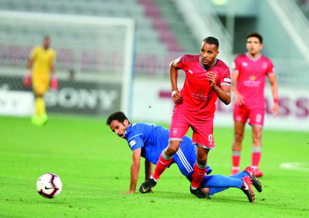 Al Duhail’s Youssef El Arabi (centre) scores against Al Shahania yesterday.