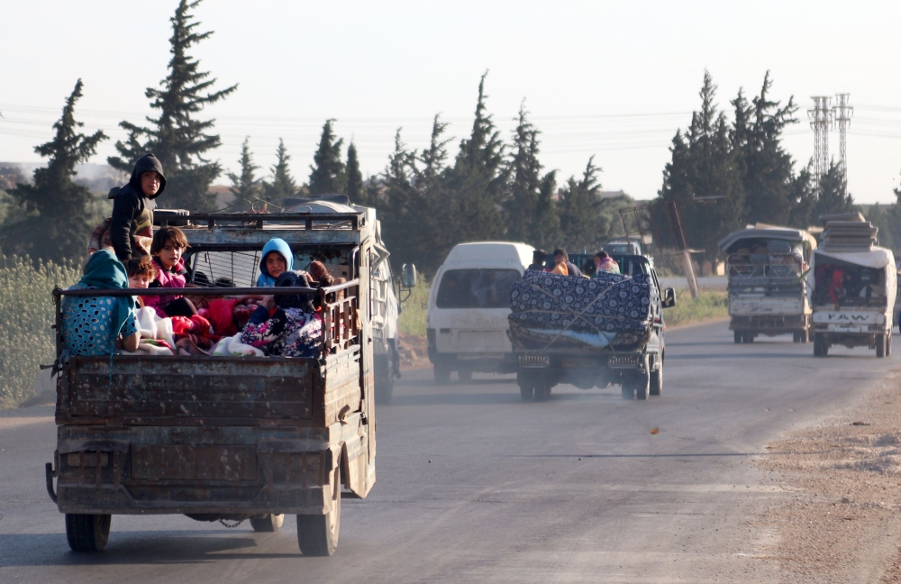 Syrians drive with their belongings along the main Damascus-Aleppo highway near the town of Saraqib in Syria's jihadist-held Idlib province on May 9, 2019 as they flee possible air strikes by the regime and its allies in the area.   AFP / Anas AL-dyab