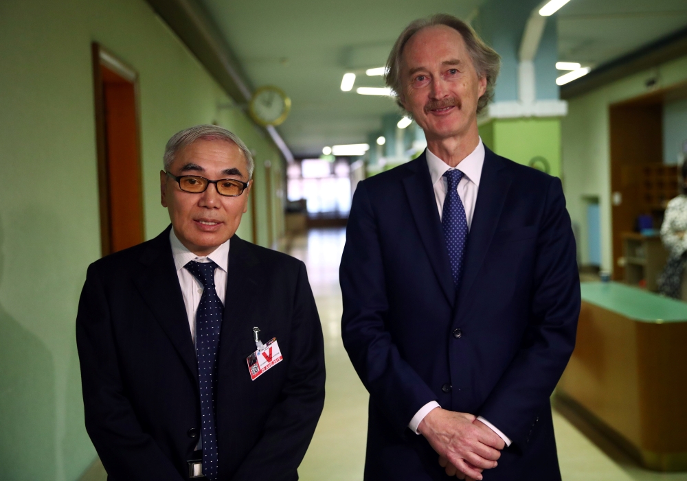 Chinese Special Envoy Xie Xiaoyan and U.N. Special Envoy Geir Pedersen talk to reporters after a meeting at the United nations in Geneva, Switzerland August 20, 2019. REUTERS/Denis Balibouse