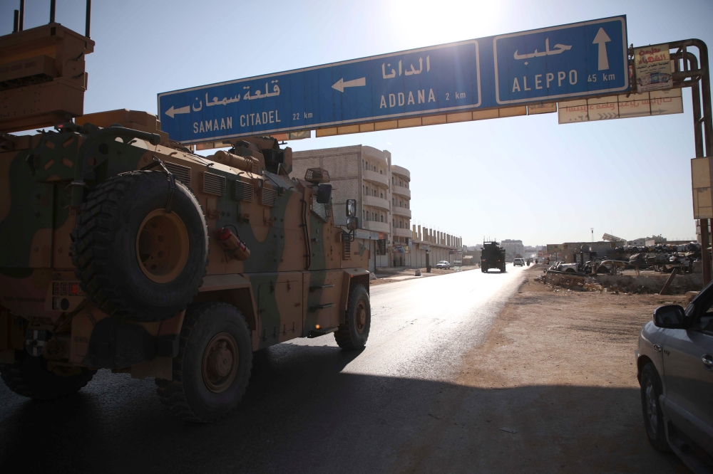 A Turkish army convoy drives along the Bab al-Hawa highway on August 24, 2019, on their way to reinforce a Turkish military observation point in northwestern Syria. AFP / Aaref WATAD