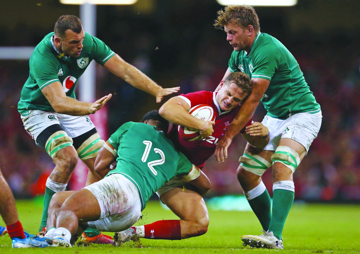 Wales' full-back Hallam Amos is tackled by Ireland's centre Bundee Aki (2nd L) during the international Test rugby union match between Wales and Ireland at Principality Stadium in Cardiff, south Wales on August 31, 2019. AFP / Geoff Caddick