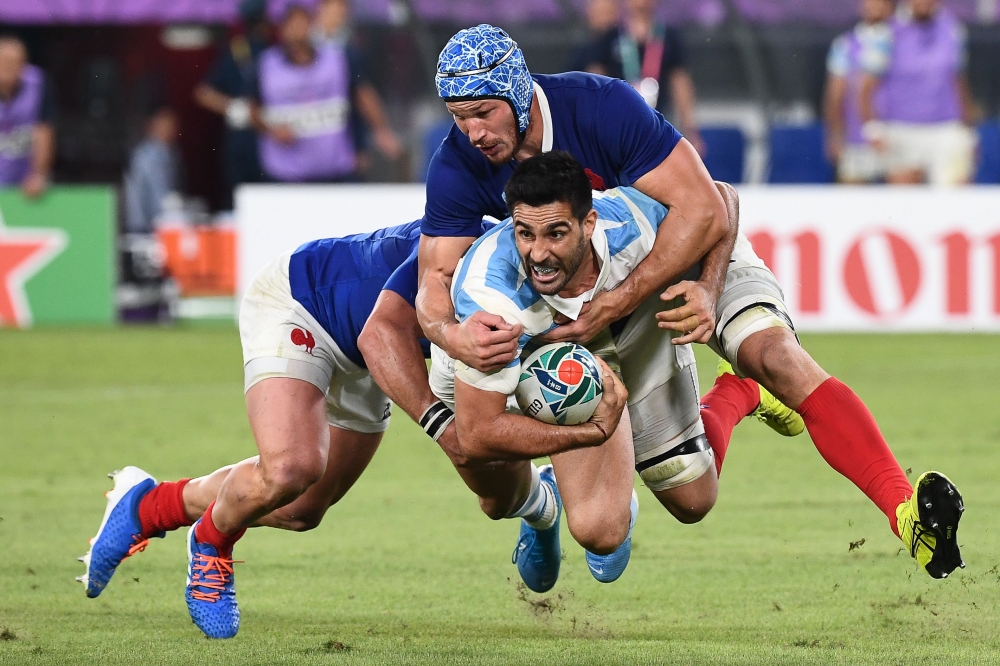 Argentina's centre Jeronimo de la Fuente (C) is tackled by France's wing Yoann Huget (L) and France's flanker Wenceslas Lauret during the Japan 2019 Rugby World Cup Pool C match between France and Argentina at the Tokyo Stadium in Tokyo on September 21, 2