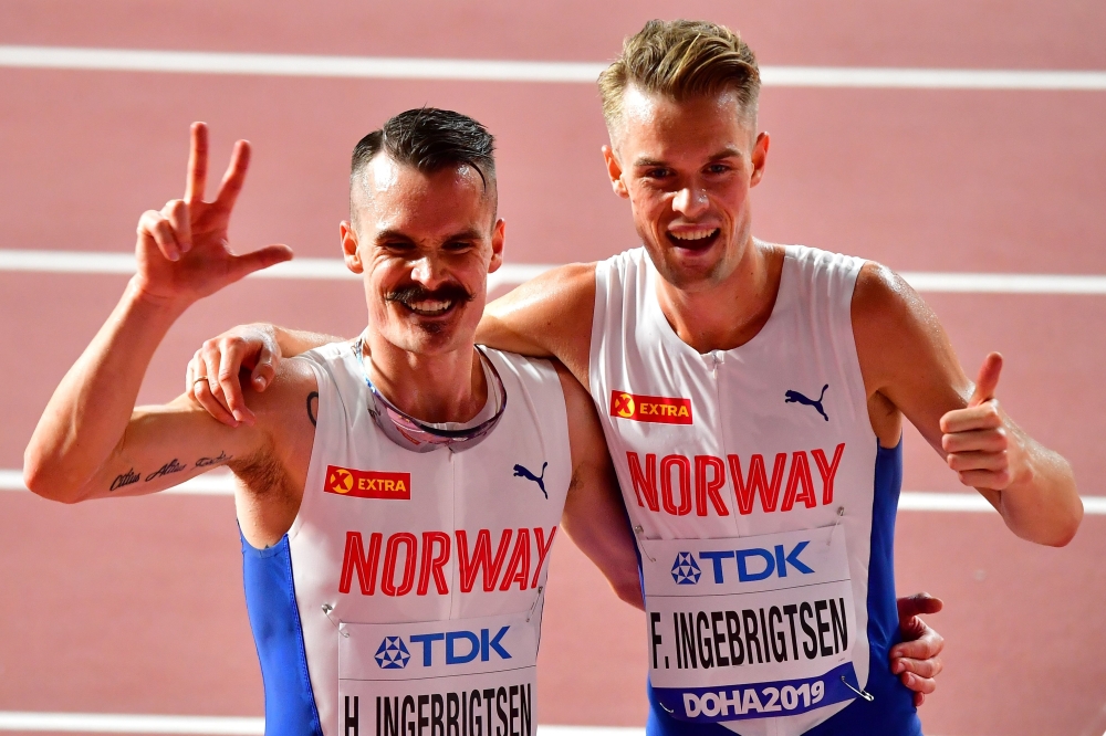 Norway's Henrik Ingebrigtsen (L) and Norway's Filip Ingebrigtsen celebrate after the Men's 5000m heats at the 2019 IAAF World Athletics Championships at the Khalifa International stadium in Doha on September 27, 2019. / AFP / Giuseppe CACACE